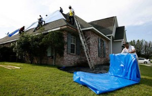 Roofing contractors providing emergency leak mitigation and tarp installation