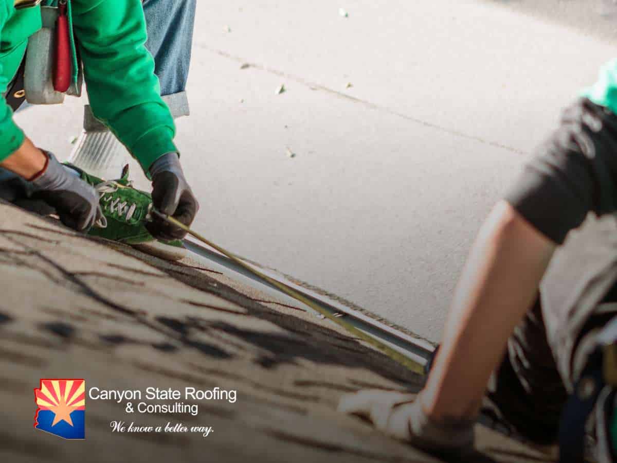 Worker inspecting a roof surface to assess the condition of Tile Roof Underlayment