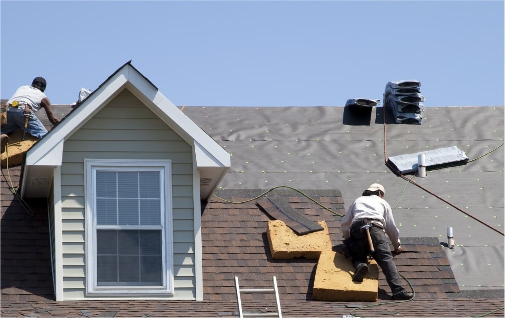 Roofers installing shingles on a residential roof in Tempe, AZ