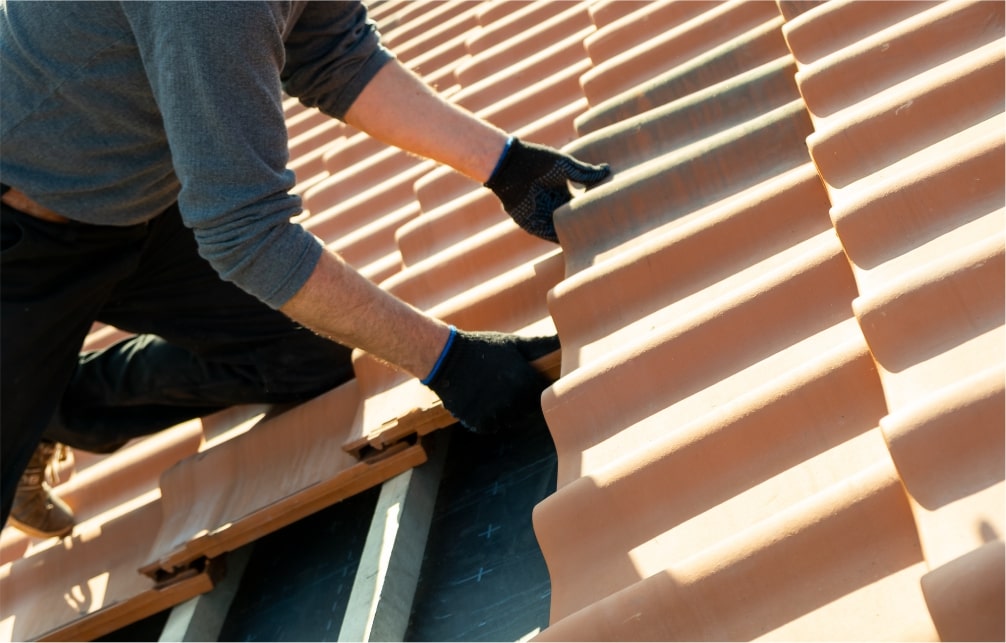 Roofing contractor working with clay tiles