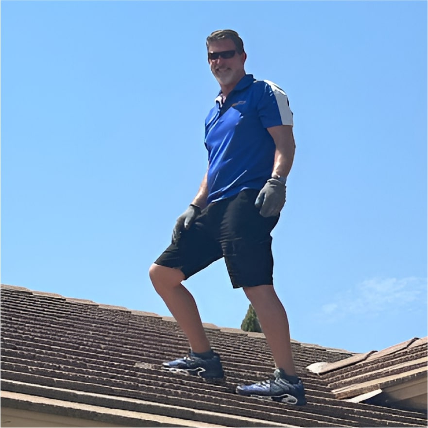 Jim McLain, Owner Of Canyon State Roofing, inspecting the work on a roof