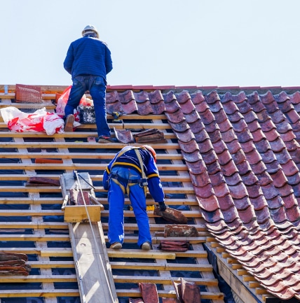 Jim McLain, Owner Of Canyon State Roofing, inspecting the work on a roof