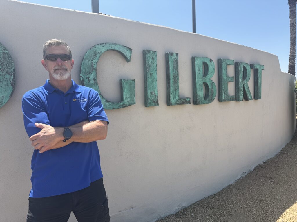 Jim McLain of Canyon State Roofing at the Gilbert, Arizona city sign