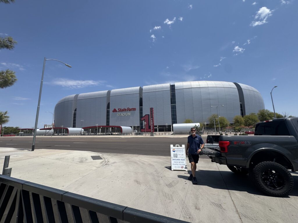 Canyon State Roofing truck and yard sign outside State Farm Stadium in Glendale, Arizona