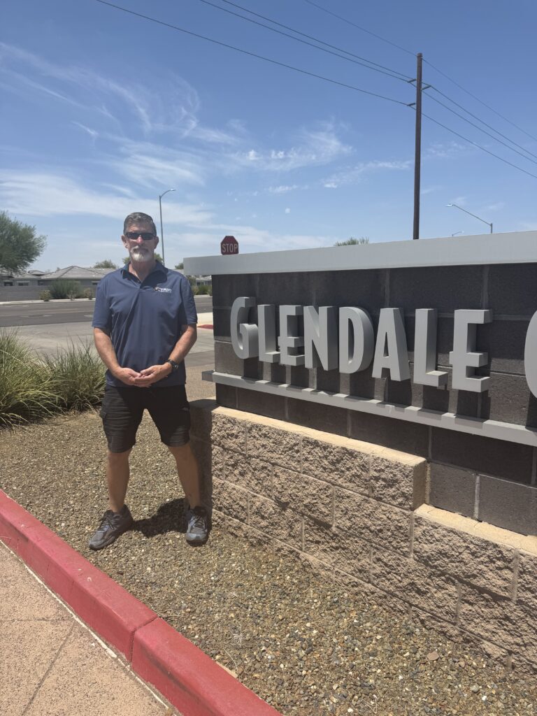 Jim McLain of Canyon State Roofing at the Glendale, Arizona city sign
